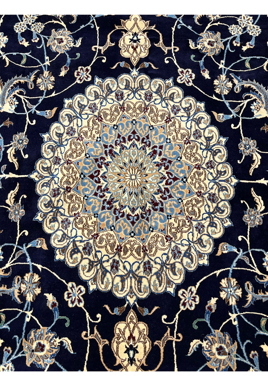 Close-up of ivory floral medallion on Persian Nain silk rug showing layered rosettes, silk highlights, fine knotting, and precise symmetrical detailing.