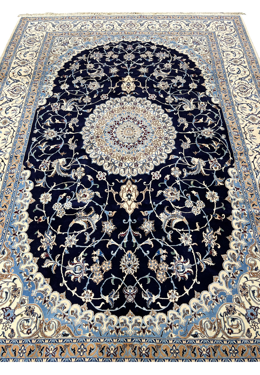 Detailed view of Persian Nain silk rug midfield featuring scrolling vines, floral motifs, silk accents, and balanced spacing on deep navy background