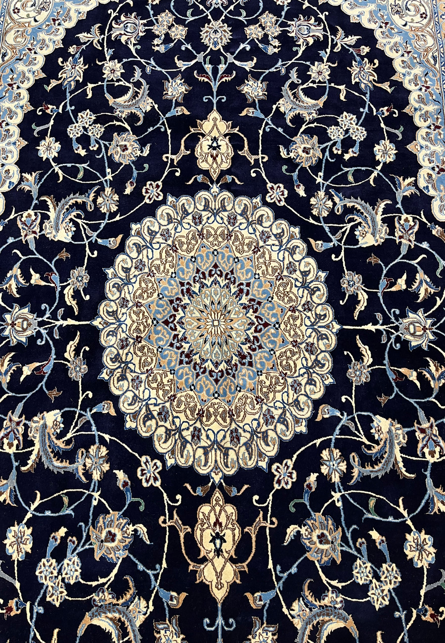 Midfield floral close-up of Persian Nain 6 LA silk rug revealing silk highlights, fine outlines, and intricate botanical motifs on navy field