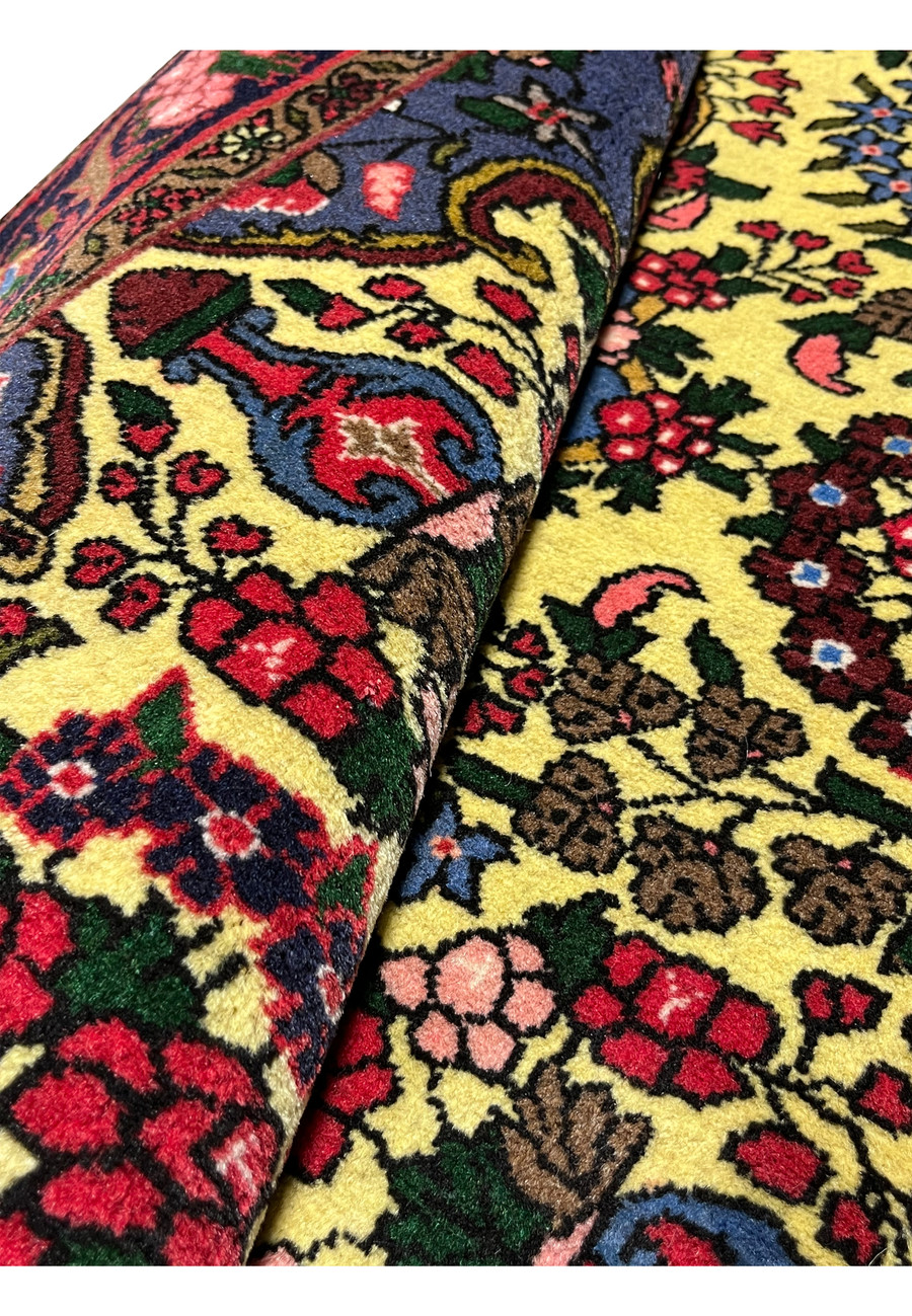 Rolled Persian Bijar rug showing thickness, weight, and compact structure created by traditional wet-weft Bijar weaving technique