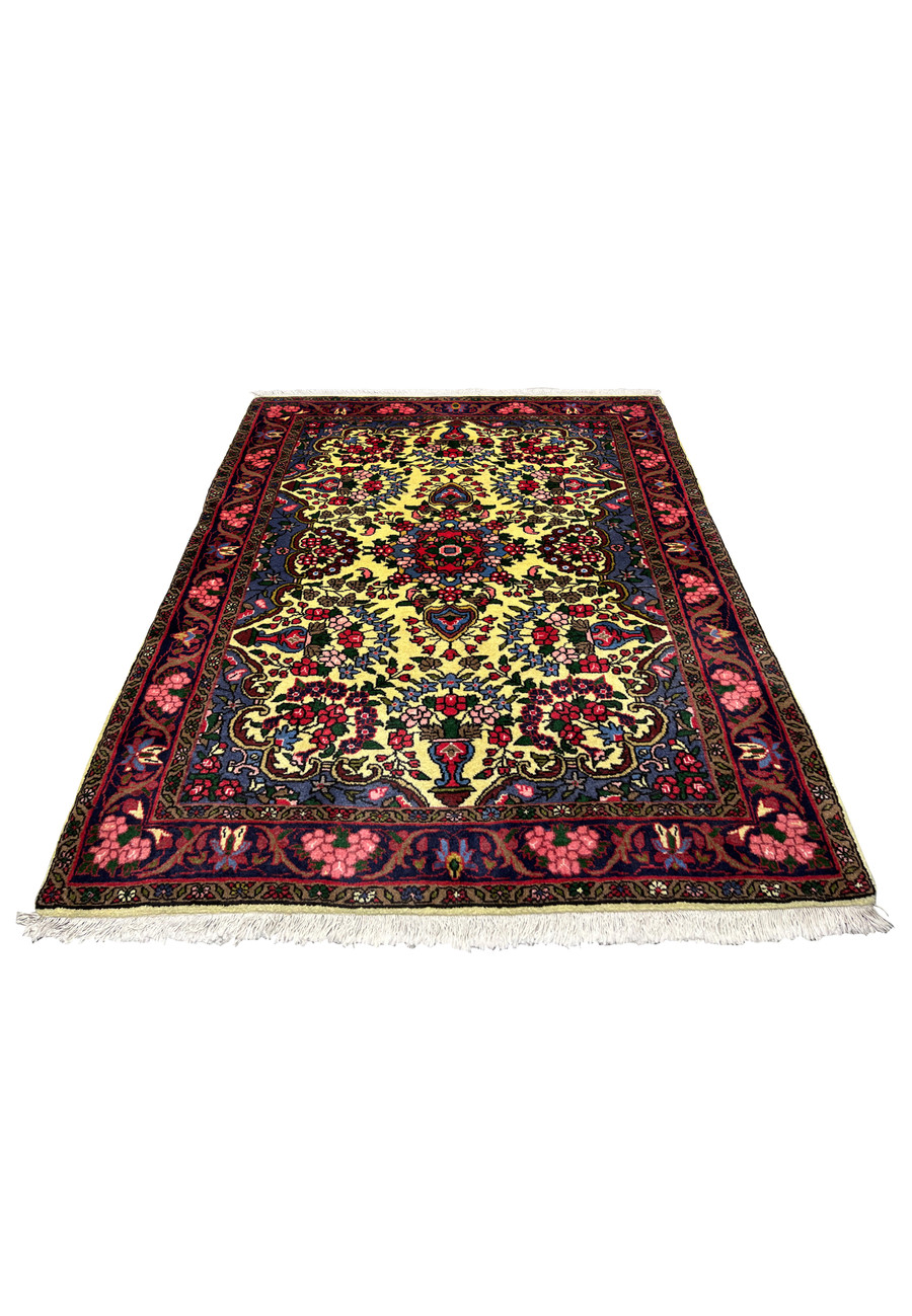 Small Persian Bijar rug laid flat showing golden yellow field, rich red floral borders, and tightly woven wool structure typical of traditional Bijar rugs