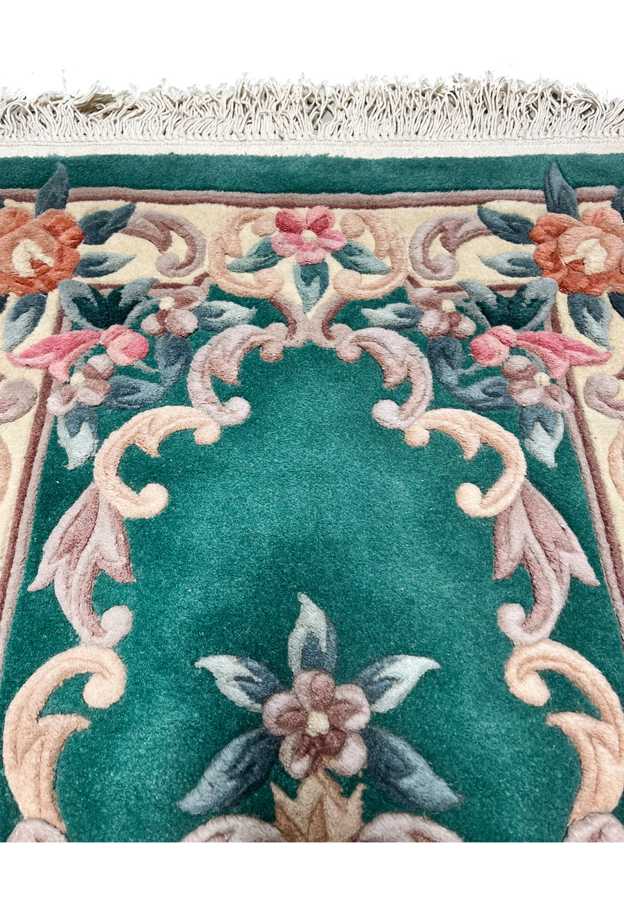 Upper part of this 2'3 x 4'7 Foral 3D Aubusson Art Deco Rug highlighting the floral pattern and deep emerald green field.