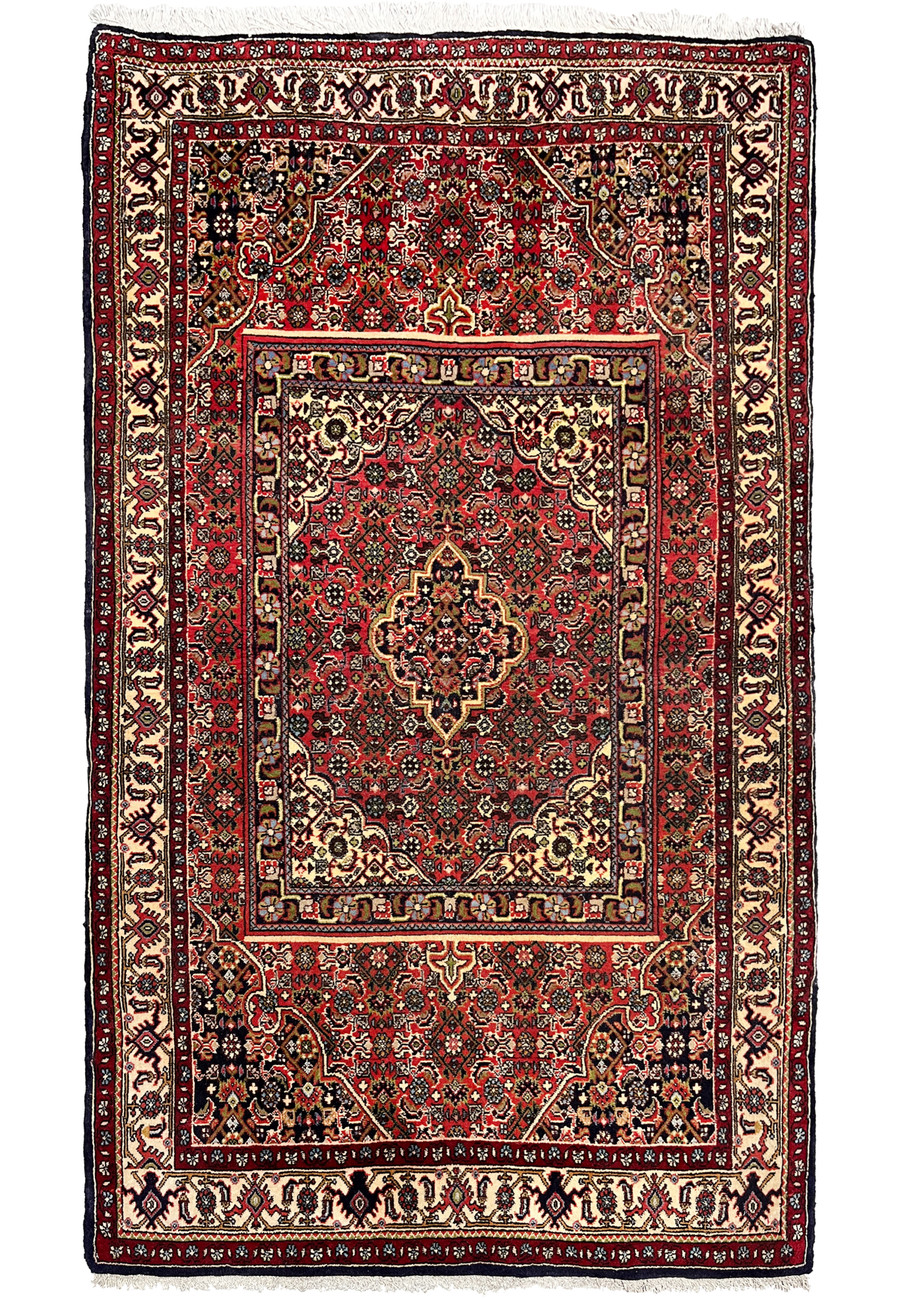 Full view of a 3 x 5 Persian Bijar rug featuring a rug-in-rug design, deep red field, ivory borders, dense wool pile, and structured symmetry