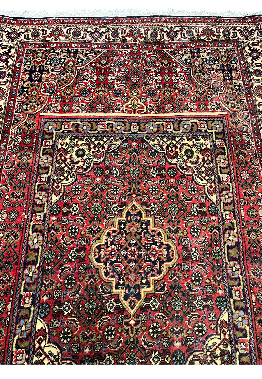 Central medallion detail of a Persian Bijar rug highlighting intricate geometry, ivory highlights, dark outlines, and dense iron-rug construction