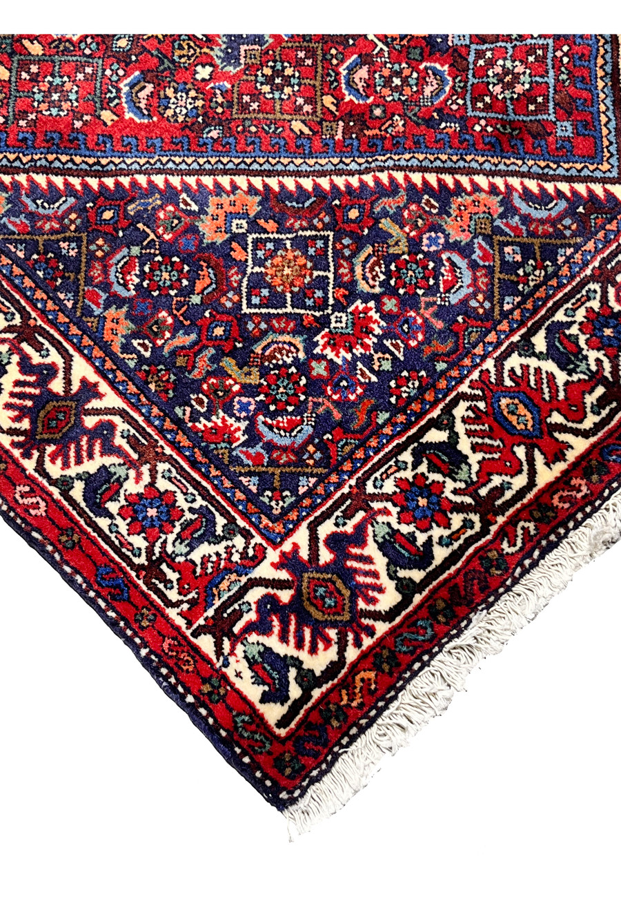 Side edge detail of a hand-knotted Persian Gholtogh rug showing tight knot structure, clean selvedge, and consistent wool pile.