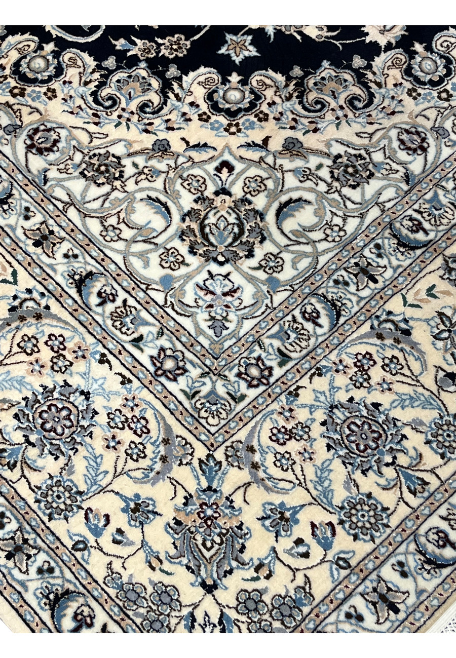 Inner border detail of Persian Nain 6 LA silk rug highlighting fine floral repetition, light blue accents, and sharp silk definition