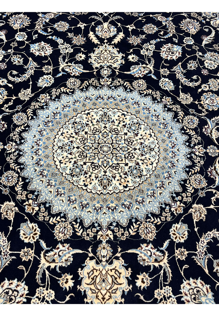 Detailed medallion of Persian Nain 6 LA Habibian rug featuring ivory and light blue silk, symmetrical geometry, and refined floral articulation