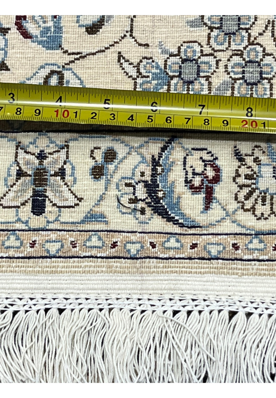 Detailed backside view of a 7x10 Persian Nain 6LA Habibian rug with ruler for scale, highlighting knot consistency, silk and wool foundation, and refined hand-knotting