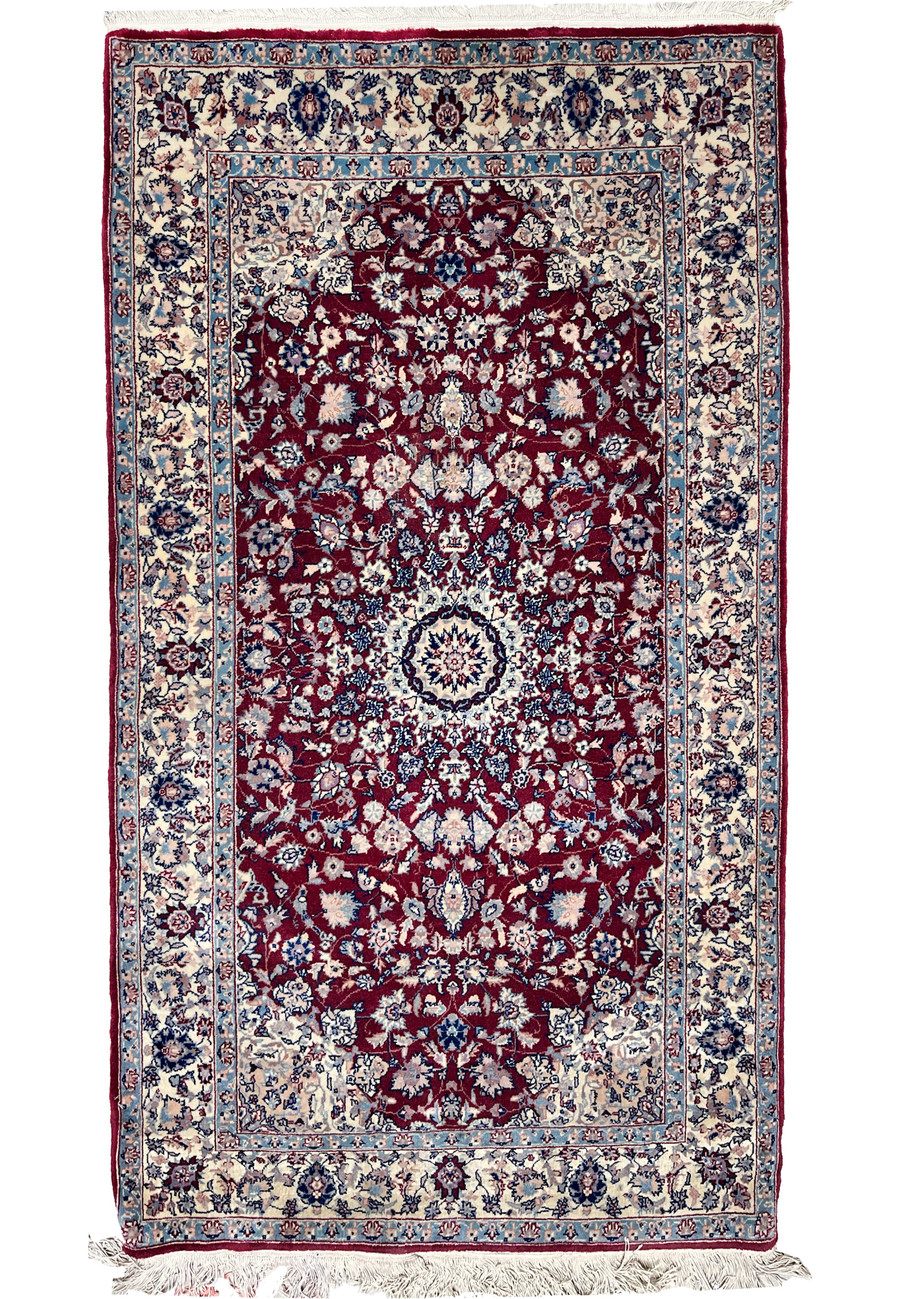 Full view of a 3' x 5'3 Persian Tabriz rug featuring a deep burgundy field, intricate floral medallion, and light blue and ivory borders