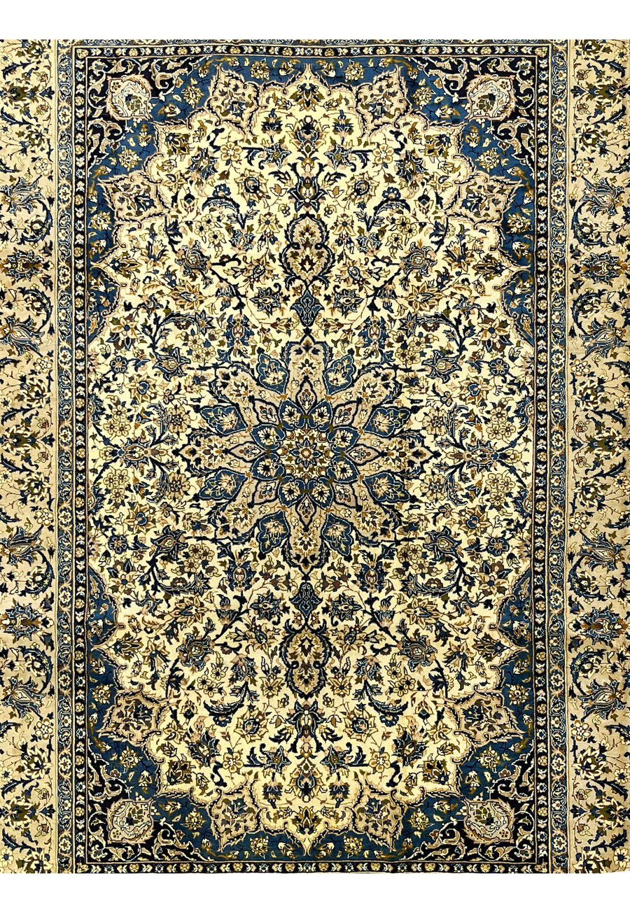 Close view of ivory midfield on Persian Kashan rug with detailed floral motifs blue highlights and fine wool knotting