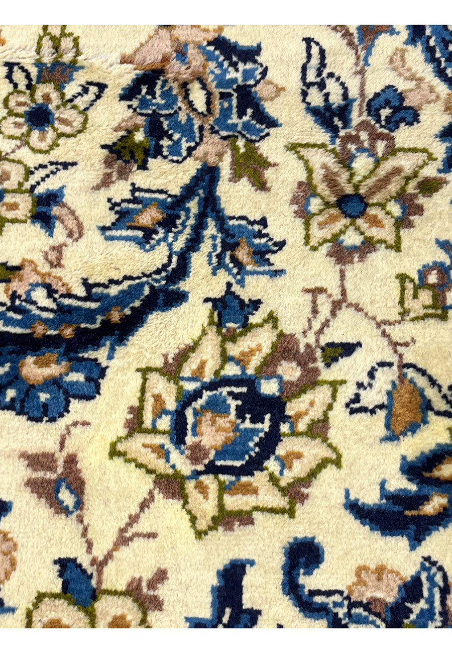 Floral motifs detail of 10'2 x 14'3 Persian Kashan rug with navy blue accents soft beige flowers olive highlights and classic medallion style