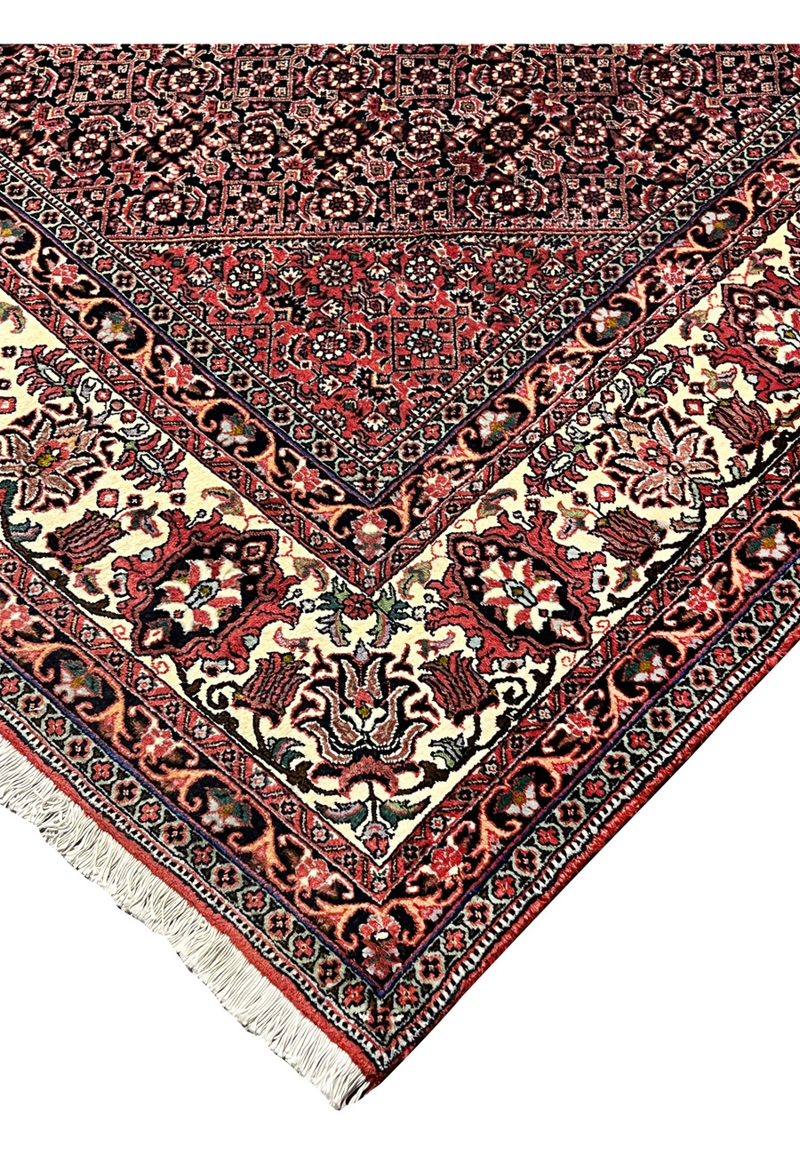 Edge and fringe view of 8'2 x 11'4 Persian Bijar Iron Rug highlighting durable iron weave, red field and ivory border detailing