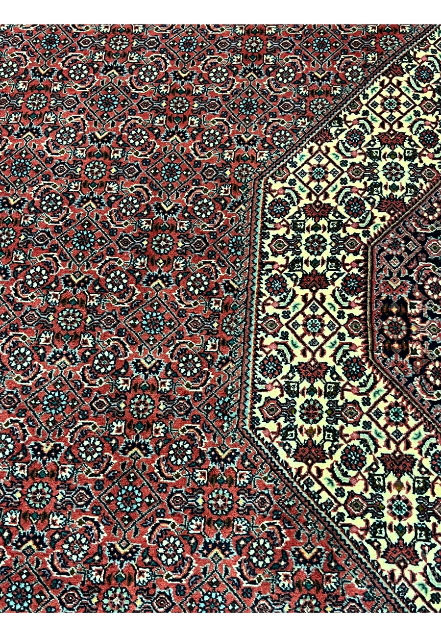 Center field detail of 8'2 x 11'4 Persian Bijar Iron Rug featuring deep red ground, repeating floral Herati motifs and ivory highlights