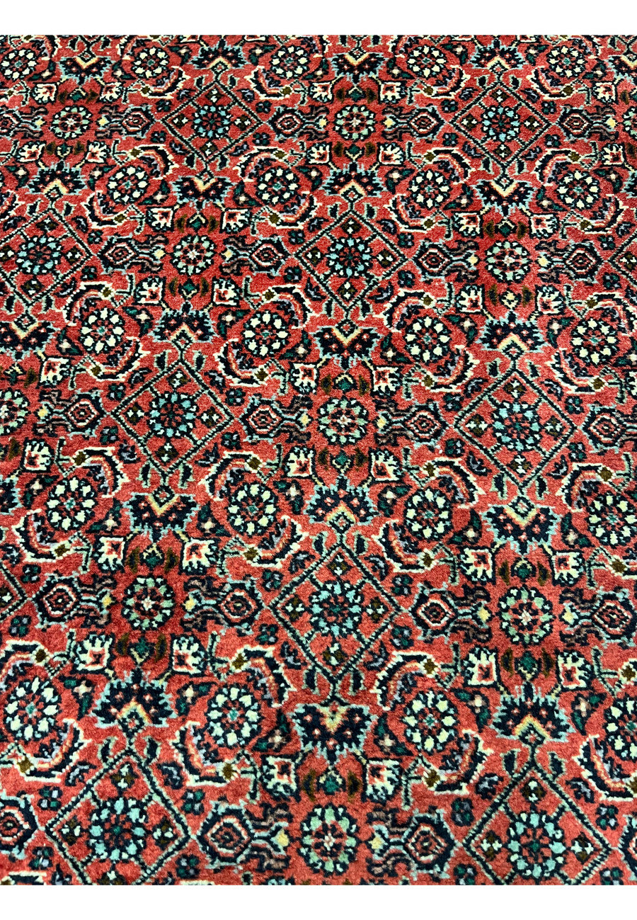 Detailed patterns and motifs of 8'2 x 11'4 Persian Bijar Iron Rug showing compact geometric floral design in red, ivory and navy tones