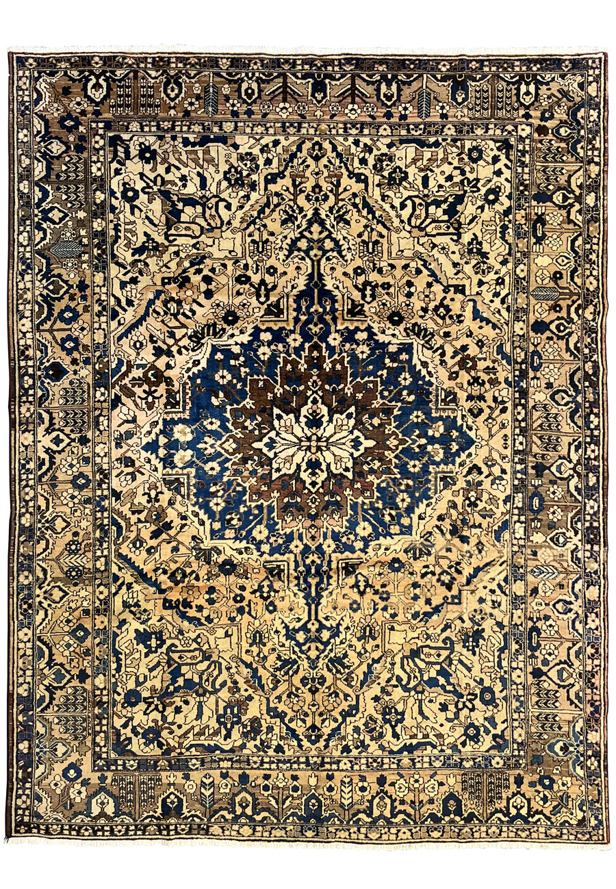 11 x 13'3 vintage geometric Persian Heriz rug in muted navy and ivory featuring bold central medallion and large ivory field with tribal border