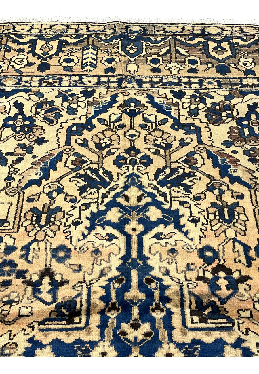 Upper field detail of 11x13'3 Vintage Persian Heriz rug in muted navy and ivory with intricate angular floral motifs and tribal symmetry