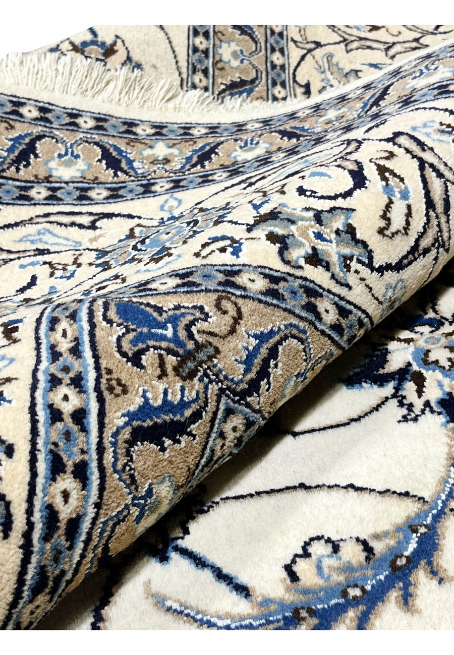 8x11 Persian Nain 9La rug partially rolled showing wool and silk pile and cotton foundation