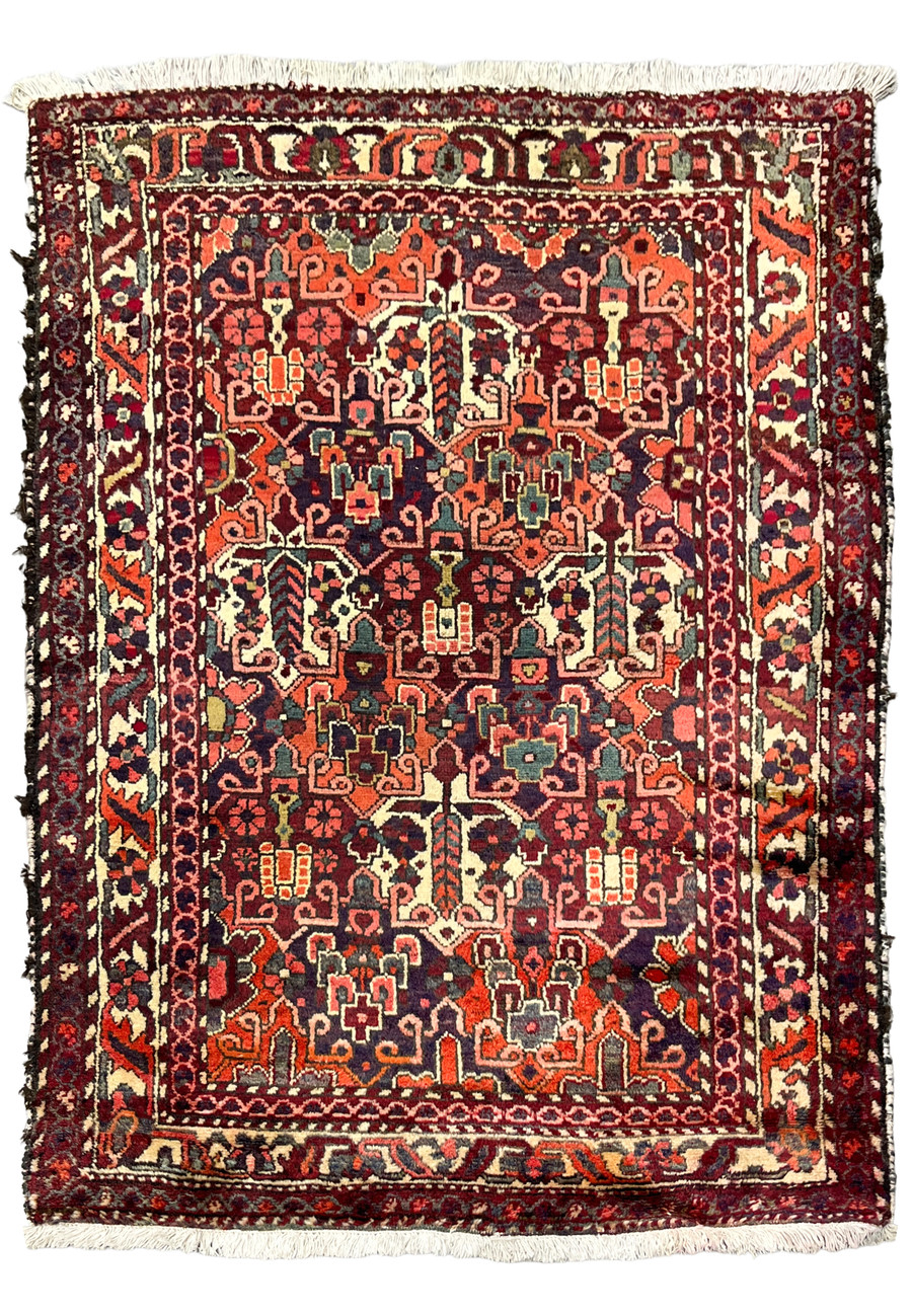 Antique 3'7"x5 Persian Bakhtiari rug, allover floral design in navy, orange and ivory, full view