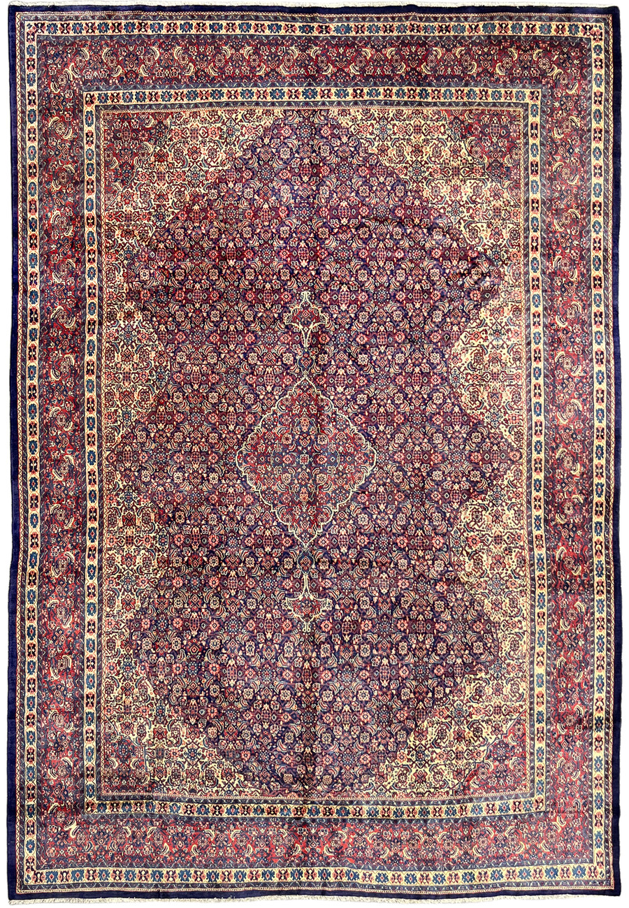 Oversize Persian Sarough rug, navy field with dense floral lattice and salmon boteh, fifteen feet long