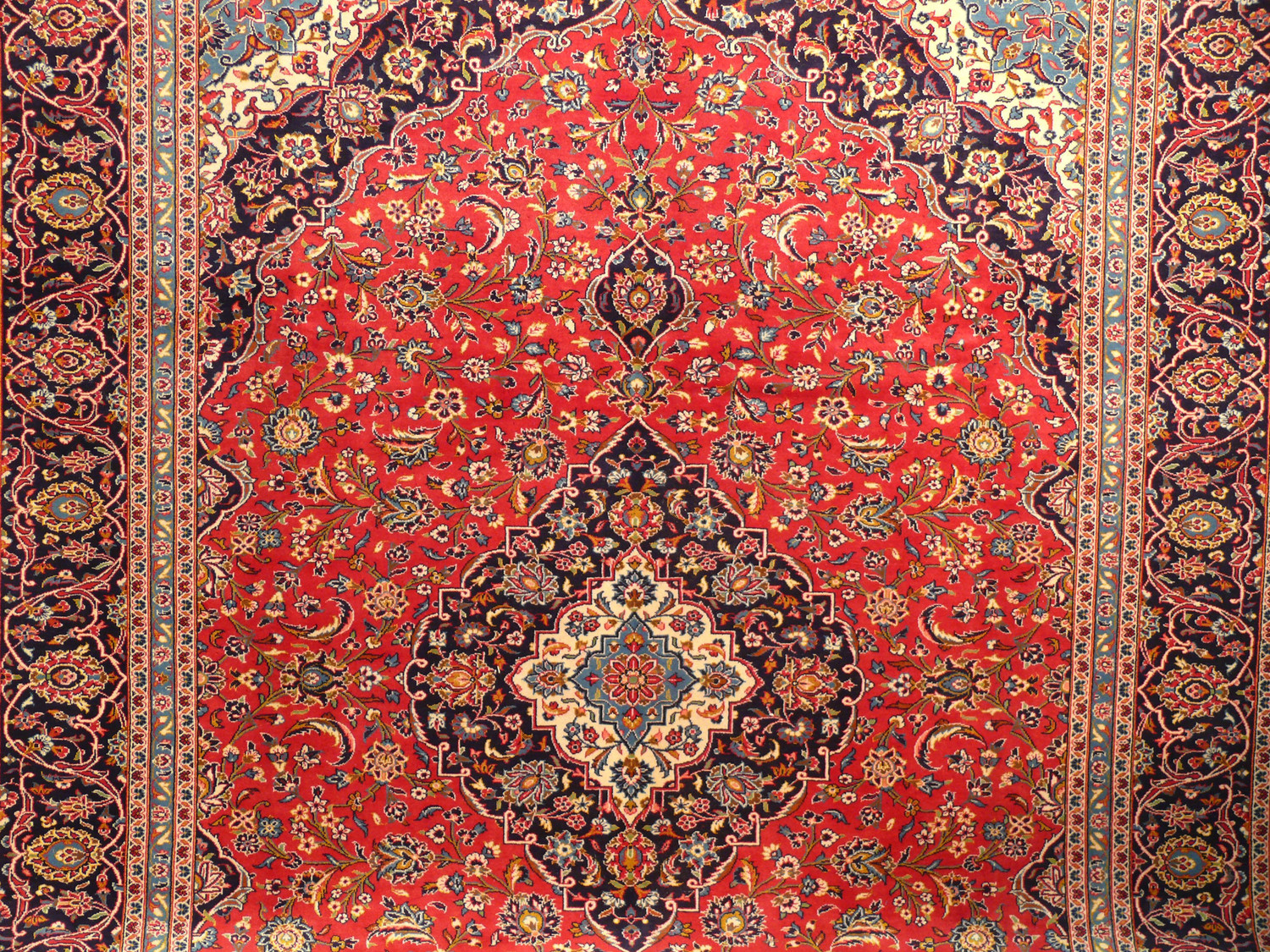 Add a touch of tradition and sophistication to your home with our 10 x 13 wool on cotton Persian Kashan rug, hand-knotted with intricate designs