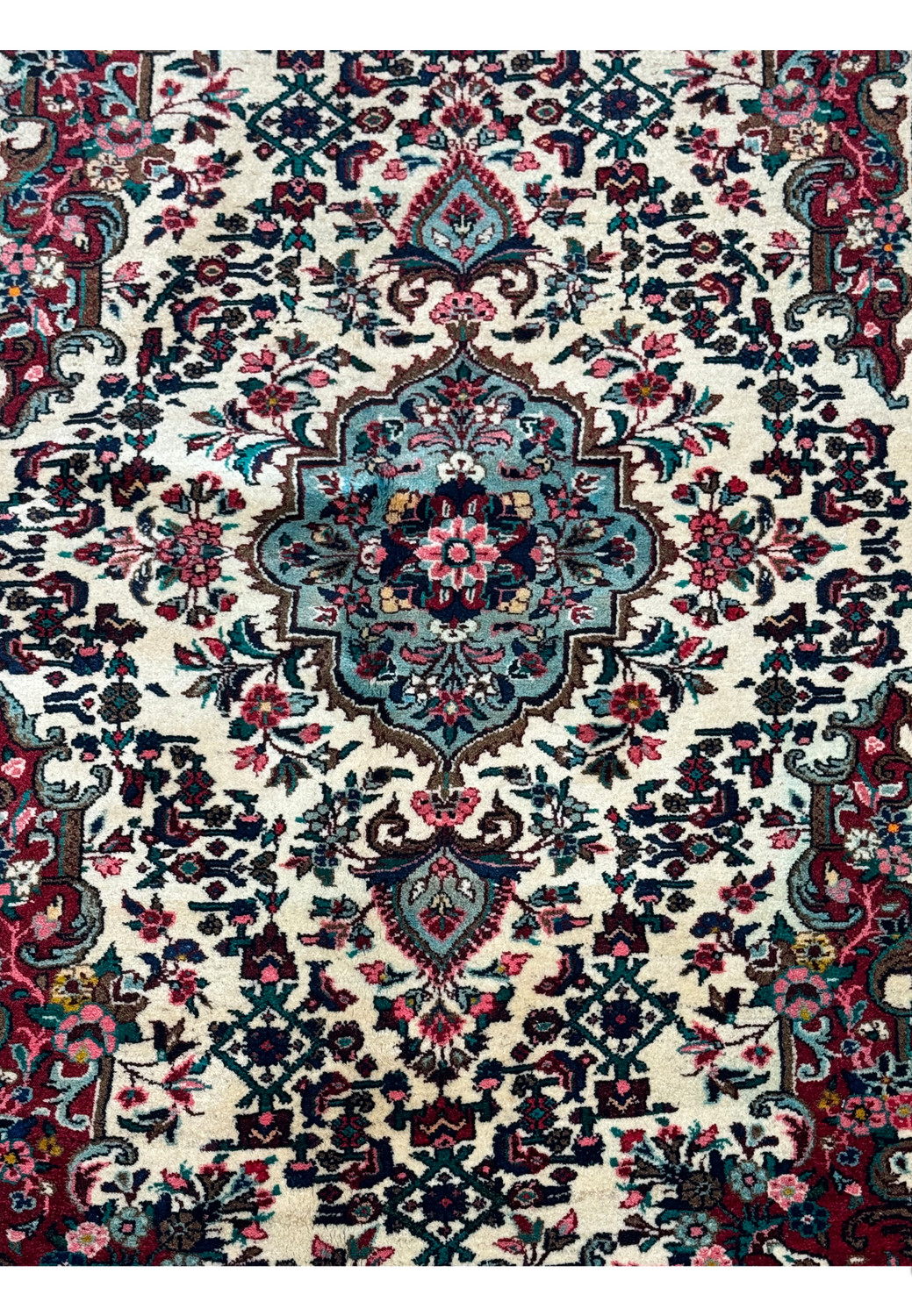 Intricate floral patterns and border details of a 4'5" x 7' Persian Bijar rug