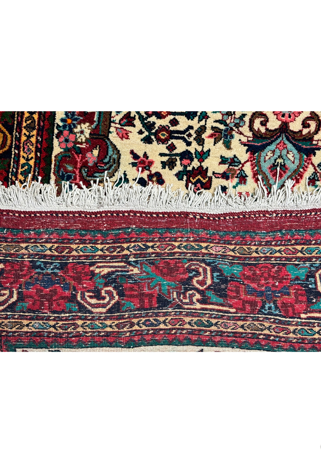 Side detail showing the dense weave and fringe of a vintage Persian Bijar rug."