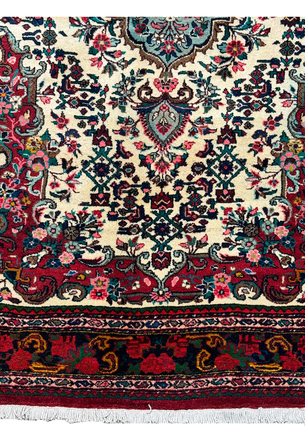 Detailed view of the central medallion and floral designs on a vintage 4'5" x 7 Persian Bijar rug