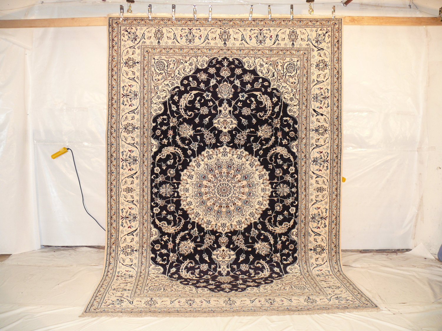 Field detail showing beige ground with vine scrolls in light brown, grey, and wine red