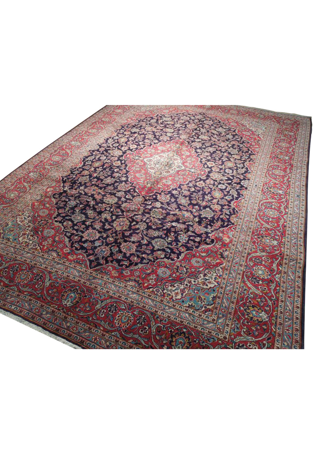 intricate Persian Kashan carpet featuring a dense floral design and traditional geometric borders in vibrant reds and deep blues, measuring 10 by 13.5 feet