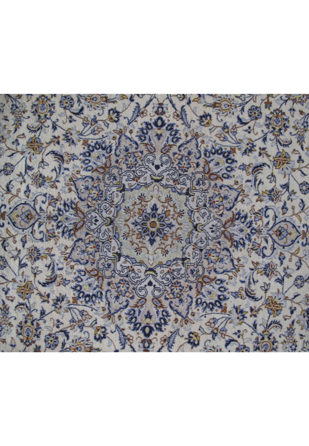 Detailed image of the central medallion on a Persian Kashan rug, showcasing the fine artistry in ivory and indigo hues