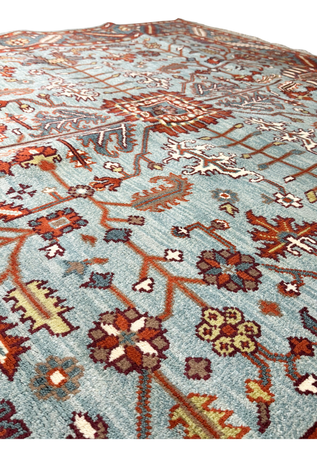 Close-up of the central pattern of an 8x8 Oushak rug, with detailed Caucasian designs woven in a vibrant mix of aqua blue, terracotta, burnt orange, and ivory colors