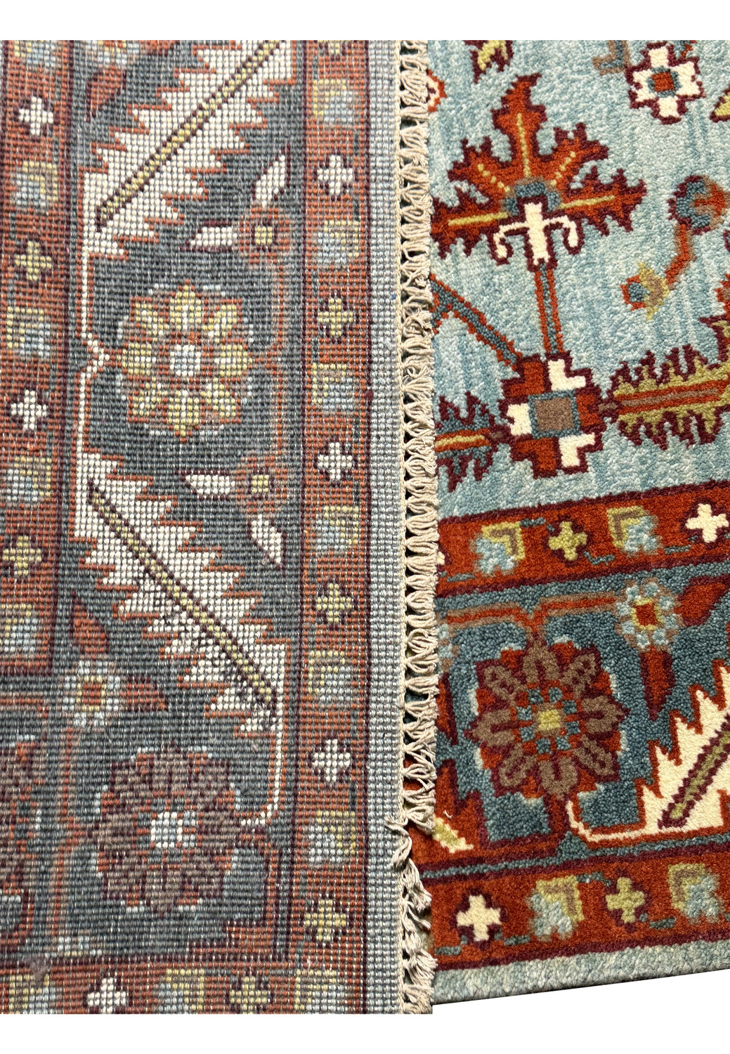 Partial view of a square Oushak rug's border, displaying the detailed craftsmanship of the Caucasian design, with a focus on the geometric and floral patterns in earthy tones