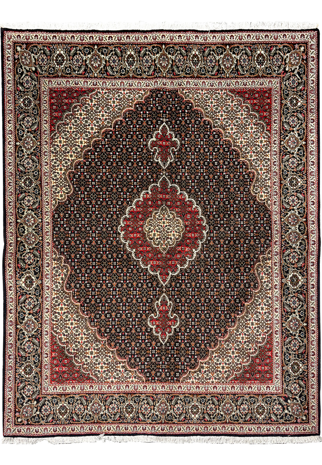 "Persian Tabriz Mahi rug edge detailing, showcasing the fine weave and complex designs in beige, red, and navy on a dark background.