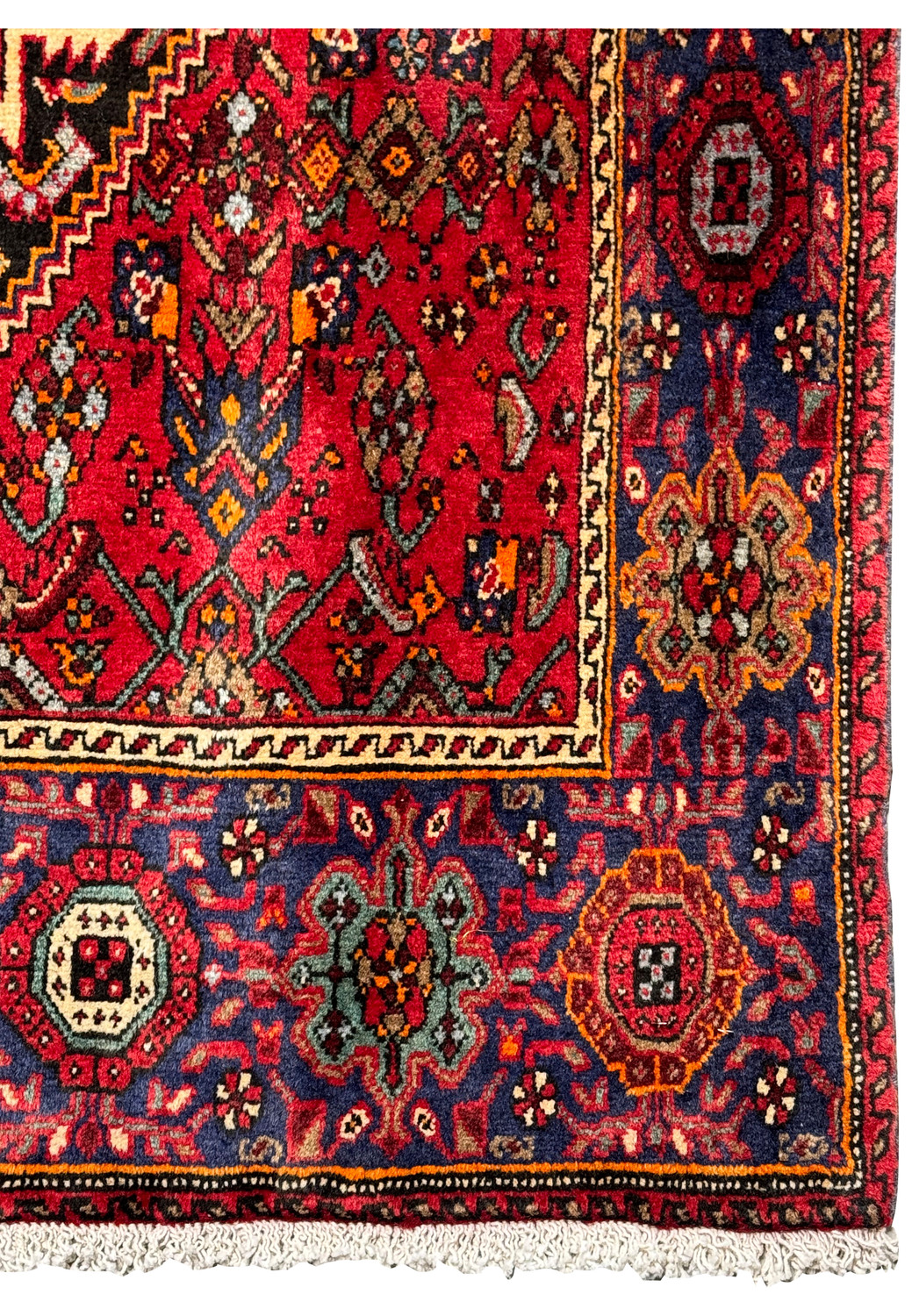 Corner detail of a 4x6 Persian Gholtogh rug highlighting the red and blue motifs