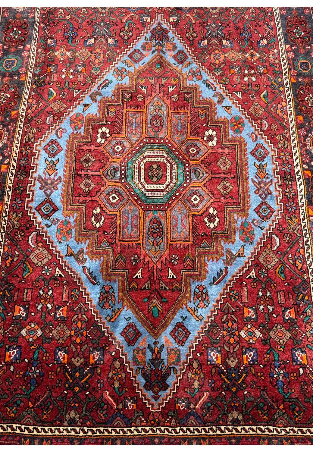 Close-up of the central diamond pattern on a Persian Gholtogh Rug highlighting the detailed craftsmanship and vibrant color contrasts.