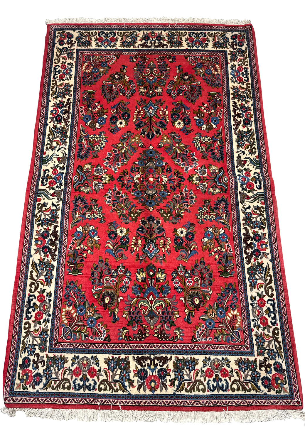 4 x 7 Persian Sarough rug laid out flat, showcasing its elaborate design. The rug features a vibrant red field with symmetrical floral patterns in navy blue, creamy beige, and accents of sky blue and white. A large diamond-shaped medallion sits at the center, flanked by quarter-medallions at each corner. The wide ivory border is adorned with repeating floral motifs and guarded by narrow blue and red guard stripes. The fringe is visible along the top and bottom edges, completing the traditional look of this handwoven piece