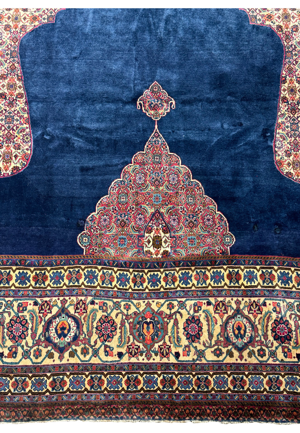 Close-up of the central mihrab design on a navy 8x8 Persian Tabriz rug.