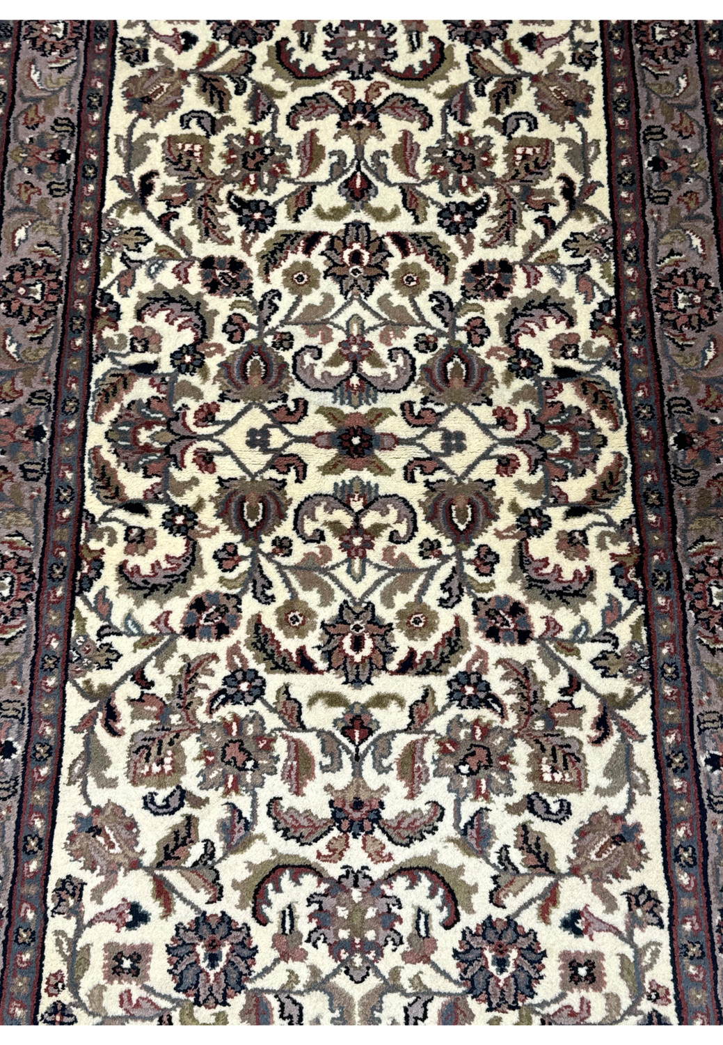 Close-up on the detailed floral patterns and border of a 3x5 Tabriz Oriental rug