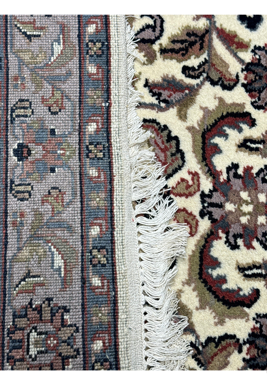 Corner detail of a 3x5 Tabriz Oriental rug, showing the fringe and edge craftsmanship