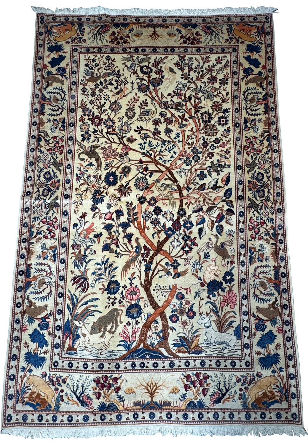 Top view of a 100-year-old Persian Kashan rug displaying the Tree of Life, with a full display of ornate border patterns and a rich color palette, in immaculate unused condition