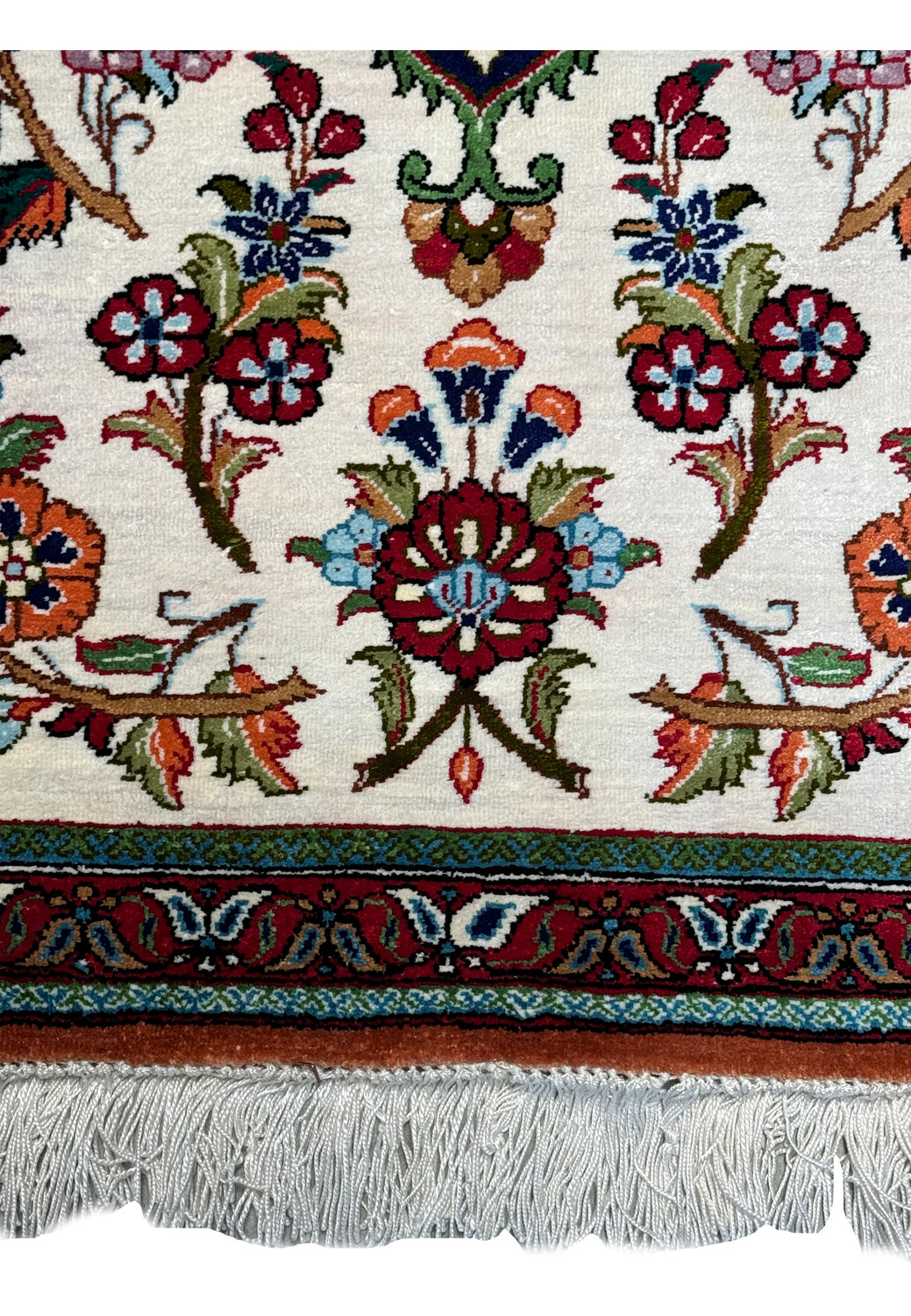 Zoomed-in view of the Persian Qum silk rug's texture and weave, with a focus on the vivid floral patterns and craftsmanship