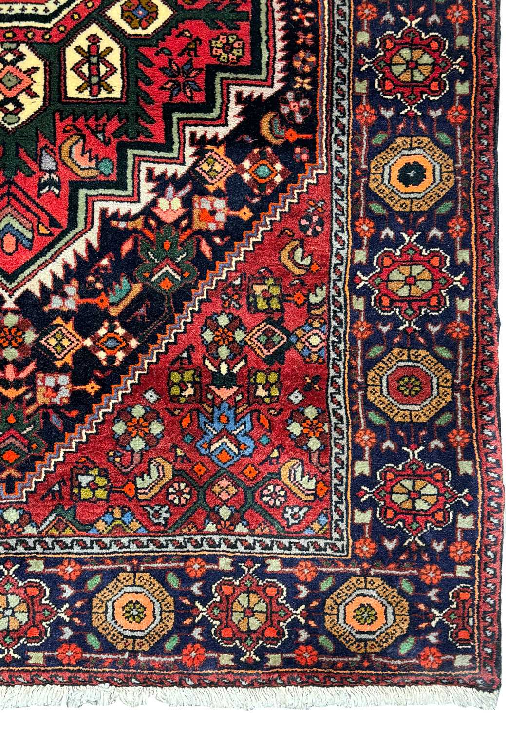 The corner of the Persian Gholtogh rug, displaying the fine craftsmanship of the border with its series of geometric and floral motif