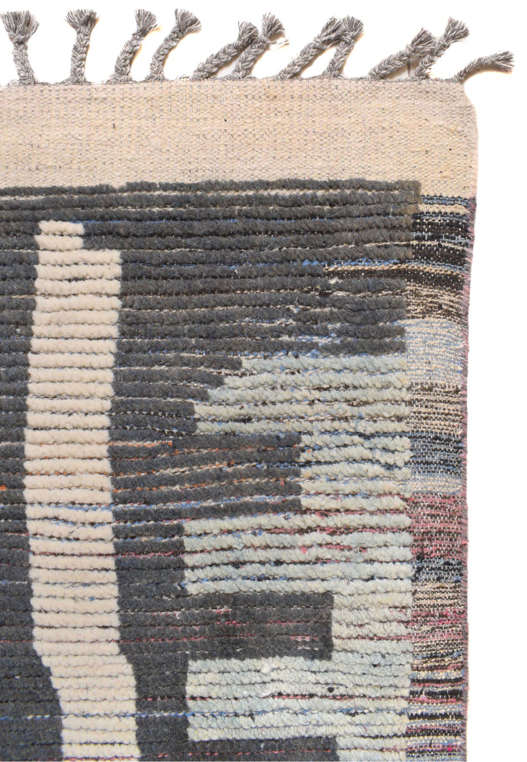 Close-up on the fringe of the Moroccan Rug, highlighting the detail in the weave and the transition of colors.