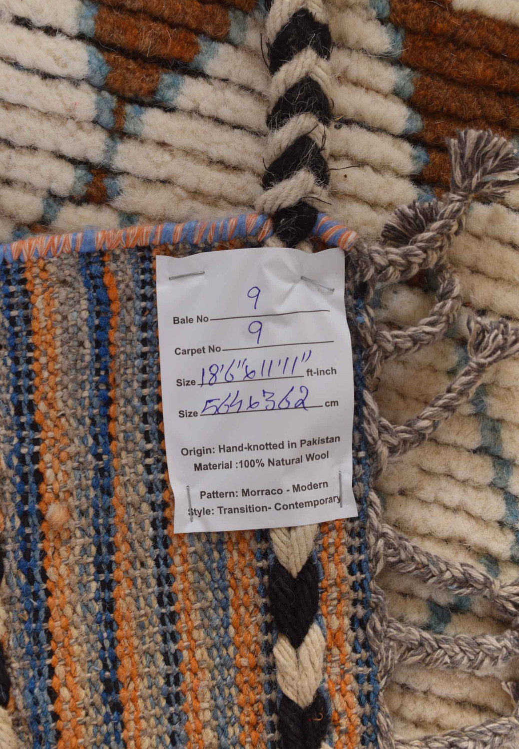 A label on a modern Moroccan rug providing details on size, origin, and material, confirming its authenticity