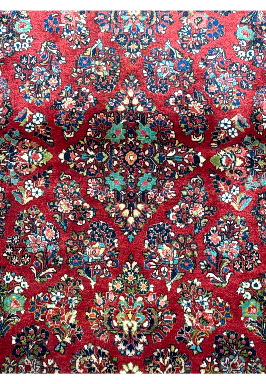 Close-up of the Persian Sarough rug's detailed weaving, highlighting the vibrant colors and traditional patterns