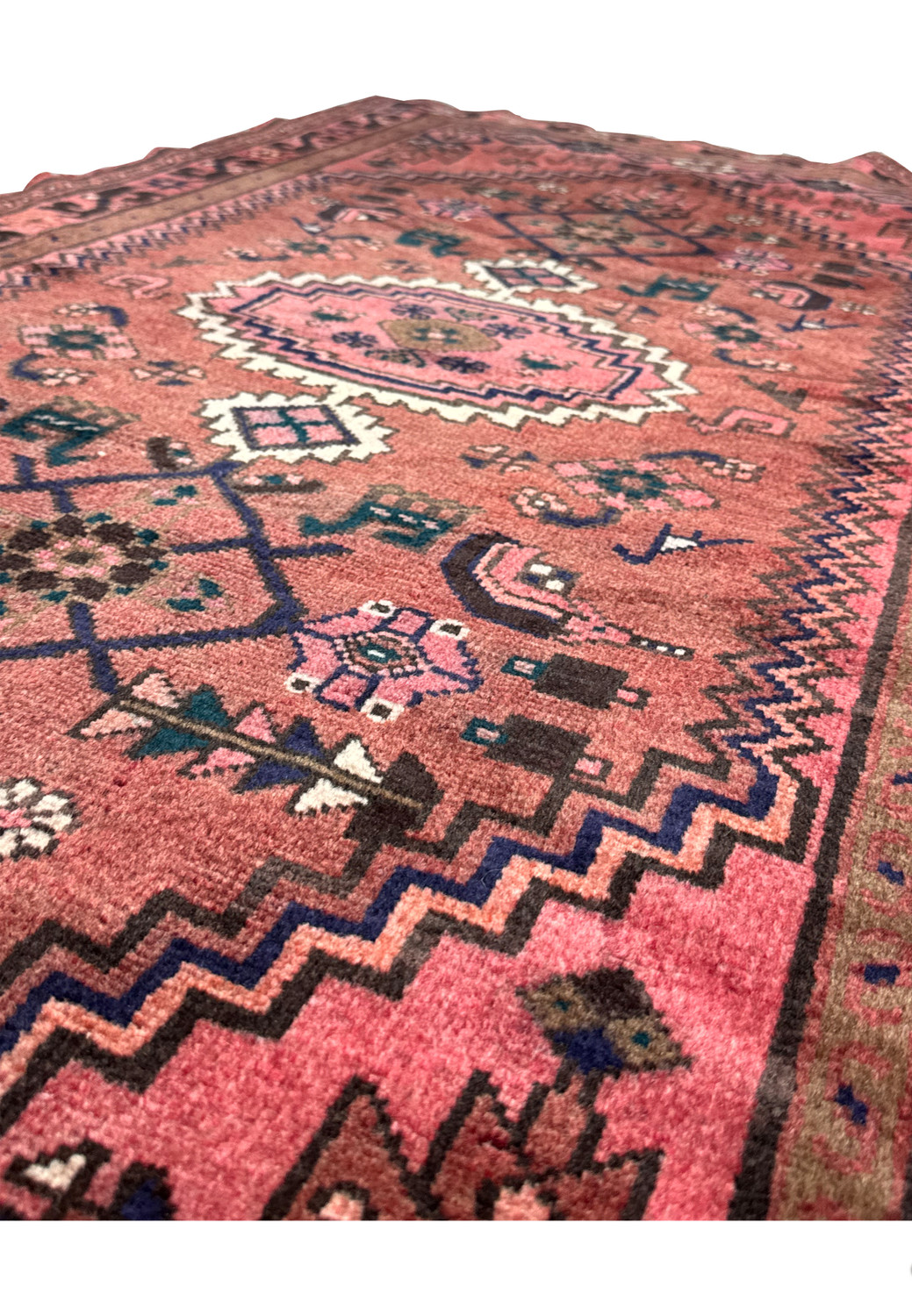 Angled perspective of the 3'5 x 6'5 Persian Baluch rug showing the texture and color variations in the weave