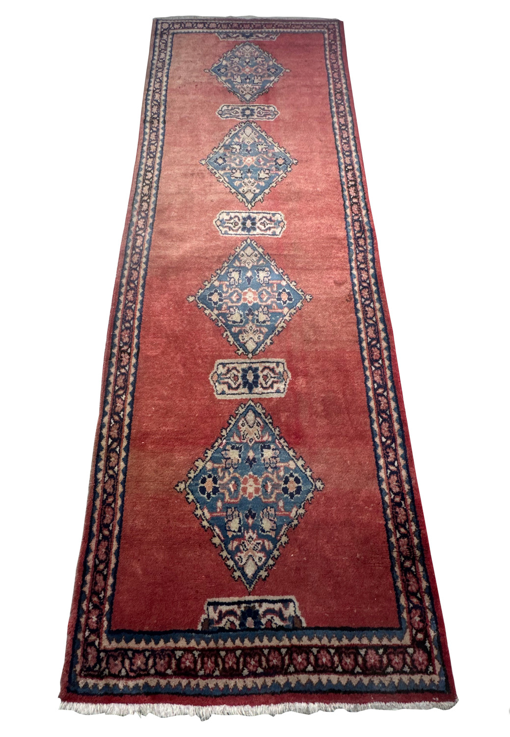 Persian Hamedan runner rug laid on the floor with detailed medallions and a floral border pattern