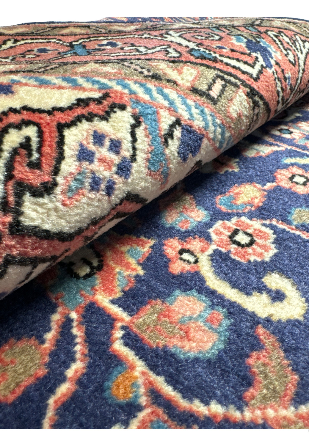 Perspective view of a folded Vintage 3x5 Persian Sarough Rug, emphasizing the thickness and quality of the weave.