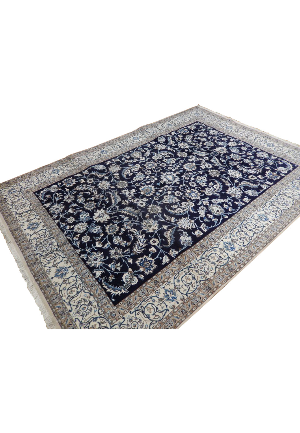 A corner angle view of the Persian Nain Rug, emphasizing the elaborate border patterns against the deep blue background
