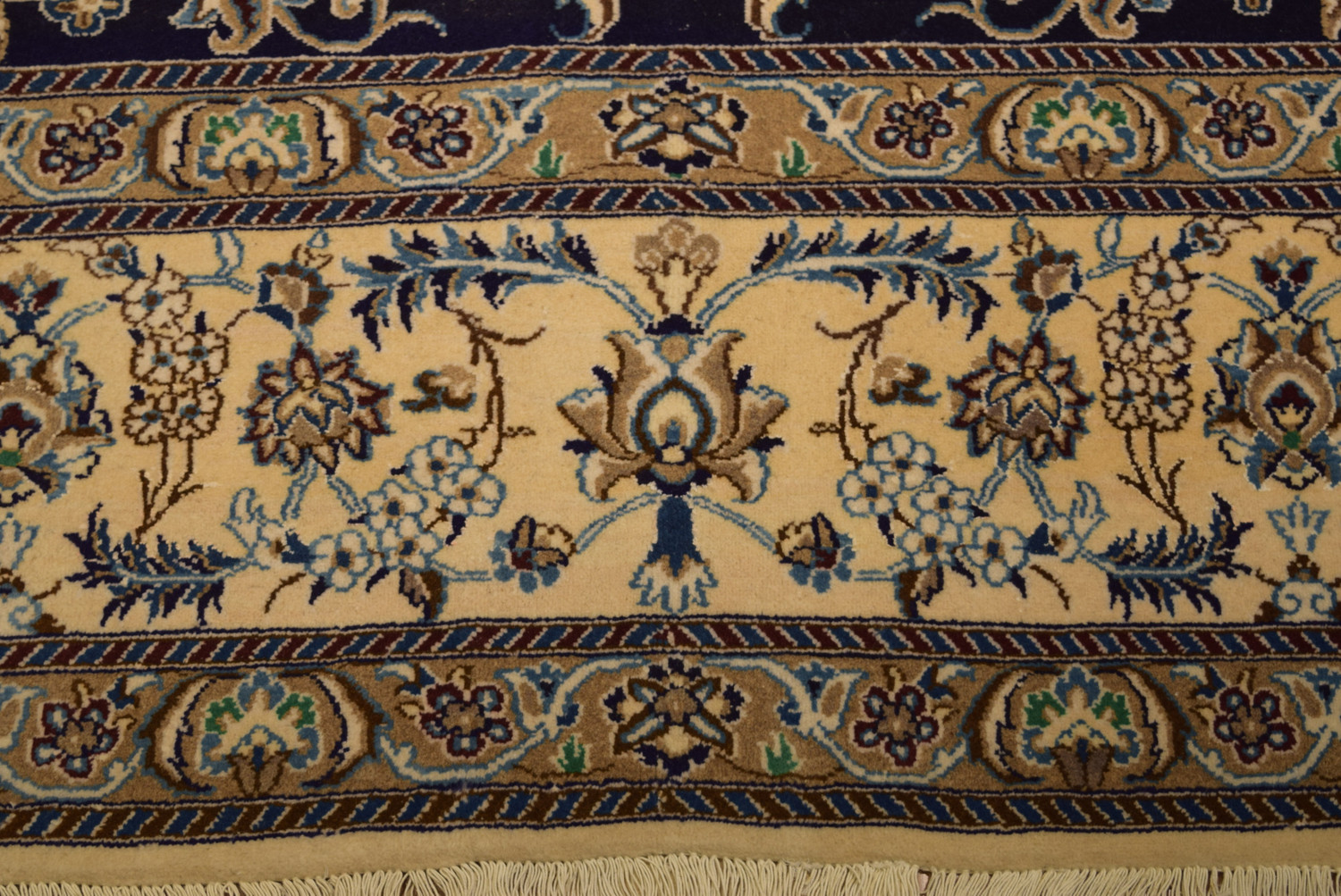 Detailed border and fringe of a Persian Nain rug highlighting the exquisite floral patterns.